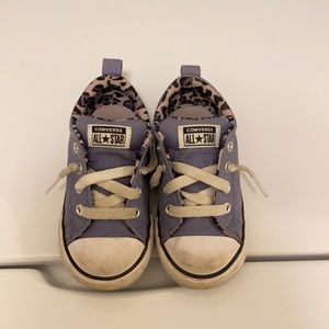 Purple converse with Cheetah print inside the shoe.